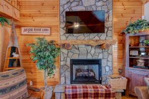 a living room with a fireplace and a tv at New River Ramble in Todd +48 photos
