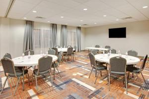 a conference room with tables and chairs and a flat screen tv at Wingate by Wyndham San Angelo in San Angelo +30 photos