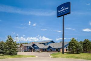 a sign in front of a building at AmericInn by Wyndham Baldwin in Baldwin