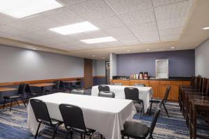a conference room with a table and chairs at AmericInn by Wyndham Baldwin in Baldwin +33 photos