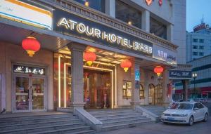 a building with a car parked in front of it at Atour Hotel (Urumqi Renmin Cinema) in Ürümqi