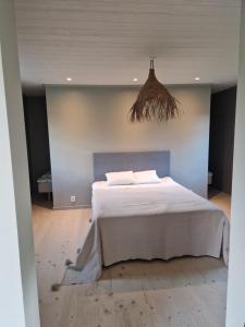 a bedroom with a large white bed in a room at Sjöstugan in Leksand