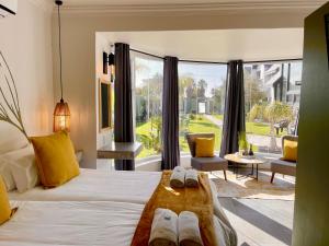 a bedroom with a bed and a large window at Olive Tree Boutique Guesthouse in Swakopmund +76 photos