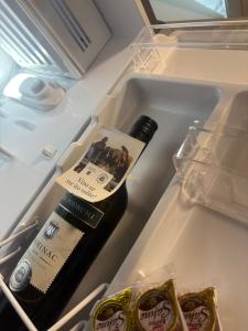a bottle of wine in an open refrigerator at Kuća za odmor Štiba in Vinkovci