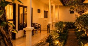 a house with a porch with chairs and plants at Noble Bali Diving Resort Tulamben in Tulamben