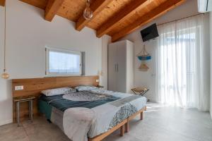 a bedroom with a large bed in a room at Agriturismo da Natalino in Ceggia