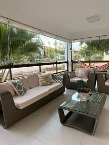 a living room with a couch and a table at Flat Hotel Canarius Gravatá in Gravatá