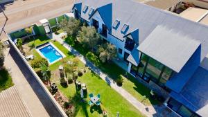 an overhead view of a house with a swimming pool at Olive Tree Boutique Guesthouse in Swakopmund