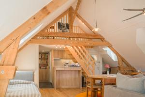 a loft conversions kitchen and living room with a staircase at La maison des jours heureux in Leysse