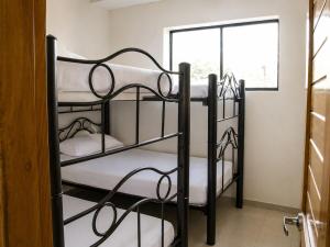 two black bunk beds in a room with a window at Prima verde in La Serena +39 photos