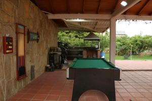 a pool table in a patio with a building at Prima verde in La Serena