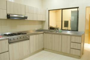 a kitchen with a sink and a stove in it at Prima verde in La Serena