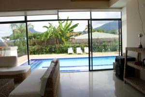 a living room with a pool and a large window at Prima verde in La Serena