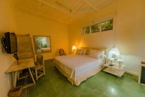 a bedroom with a bed and a flat screen tv at Hotel Boutique Casa Rosalía in Valledupar +55 photos