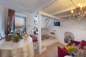 a living room with a dining table and a loft at The Sirens House in Nerano