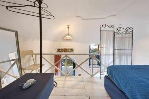 a bedroom with a bed and a table in a room at The Sirens House in Nerano