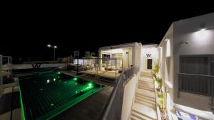 a swimming pool on the roof of a house at night at Villa Vibes Eilat Villa 26 - 8 bedrooms with private pool in Eilat