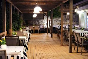 a restaurant with tables and chairs in a room at Limonata Assos in Behramkale