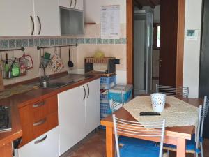 a small kitchen with a table and a counter top at Agriturismo Il Solaio in Rapolano Terme +46 photos