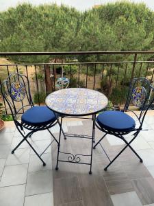 a table and two chairs on a balcony at B&B Salty Mermaid in Tropea +30 photos