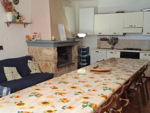 a kitchen with a table with a flower pattern on it at Agriturismo Il Solaio in Rapolano Terme