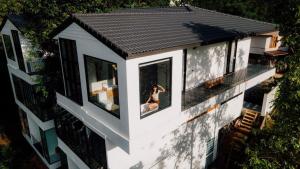 an aerial view of a house with a woman in the window at Mei Nai Home เมย นาย โฮม in Ban Sakat Nua