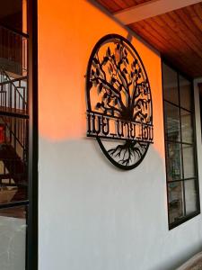 a wrought iron sign on the side of a building at Mei Nai Home เมย นาย โฮม in Ban Sakat Nua