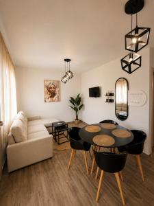 a living room with a table and chairs and a couch at Vigla summer house! in Paralia Sikias