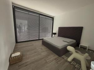 a bedroom with a bed and a large window at Chaudeney in Chaudeney-sur-Moselle