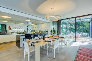 a kitchen and dining room with a table and chairs at Maison Sur l'Eau - Lugano Villa with View Terrace in Paradiso +36 photos