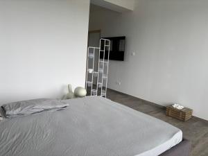 a bed in a white room with a ladder at Chaudeney in Chaudeney-sur-Moselle