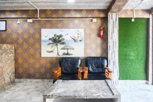 a dining room with a table and two chairs at Hotel O Champasari Siliguri Formerly Four Fox Suits in Siliguri