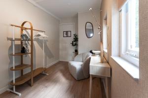 a room with a chair and a desk and a mirror at Nature Stay near Tilburg Uni & Center in Tilburg
