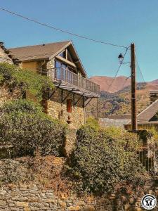 a house with a balcony on the side of it at Montmajou in Cier-de-Luchon