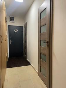 an empty hallway with a door and a hallwayngth at Modern flat in a city in Humenné