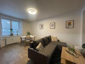 a living room with a couch and a table at Modern flat in a city in Humenné