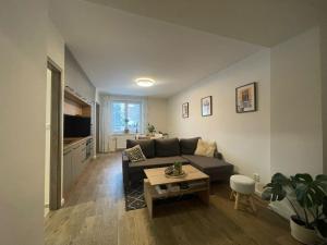 a living room with a couch and a table at Modern flat in a city in Humenné