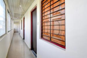 a hallway in a building with a painting on the wall at Hotel O Kanchenjunga Stadium Formerly Bindhan's Inn in Siliguri