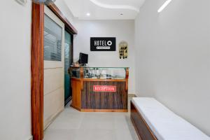 a restaurant with a counter and a sign on the wall at Hotel O Kanchenjunga Stadium Formerly Bindhan's Inn in Siliguri