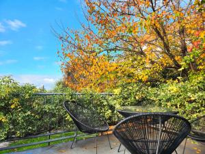 two chairs and a table on a patio at Spacious Guest Room 7 Sleeps 5 Near Shops with Free Parking in Highett