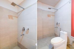 a bathroom with a toilet and a shower at Hotel O Kanchenjunga Stadium Formerly Bindhan's Inn in Siliguri