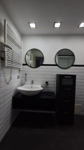 a bathroom with a sink and two mirrors at Casa Mia in Cosenza