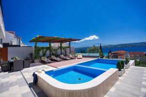 a swimming pool on the roof of a house at LUXURY VILLA PARADISE 120m from sandy beach, heated pool, billiard, max 12 pax in Duće