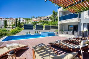 a villa with a swimming pool and a patio at LUXURY VILLA PARADISE 120m from sandy beach, heated pool, billiard, max 12 pax in Duće +54 photos