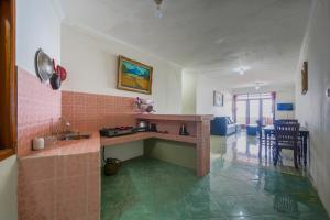 a kitchen with a sink and a counter top at Villa Tjokro 1 By ARBA in Sampal 2
