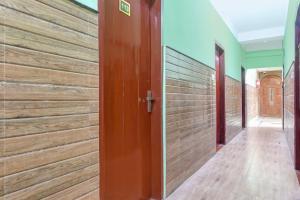 a wooden wall in a hallway with a door at Hotel O Eastern Crossway Siliguri Formerly Utsho in Siliguri