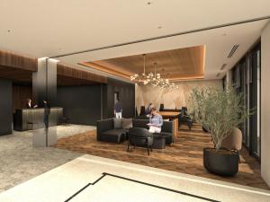 a lobby of a hotel with a woman sitting on a couch at Nest hotel alt Sapporo Odori in Sapporo