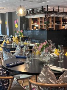 a dining room with tables and chairs with wine glasses at Best Western Hotel Halland in Kungsbacka