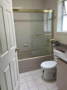 a bathroom with a shower and a toilet and a sink at 温哥华温西别墅民宿47 in Vancouver