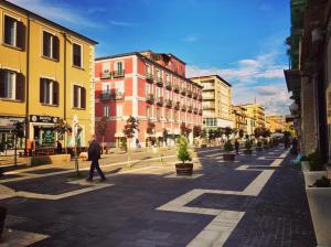 a person walking down a city street with buildings at Casa Mia in Cosenza
